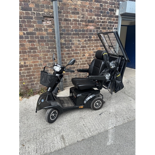 1036 - A Sterling S700 road legal 8mph long range mobility scooter with foldable weather cover