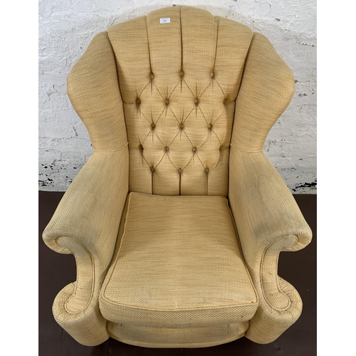 152 - A 19th century style yellow upholstered wing and button back armchair - approx. 109cm high x 86cm wi... 