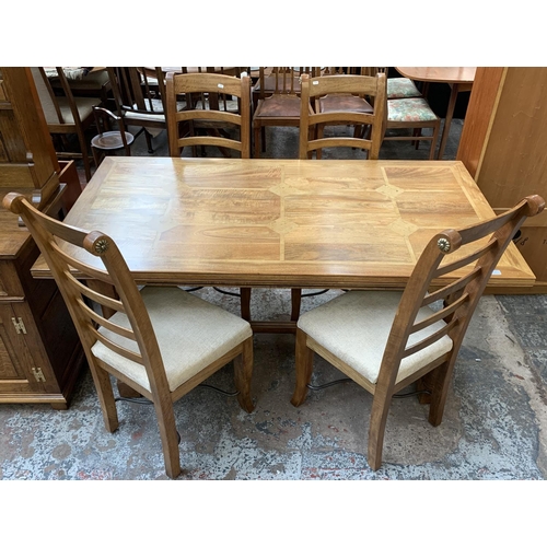 159 - A modern hardwood and walnut inlaid rectangular dining table with lower stretcher and four matching ... 