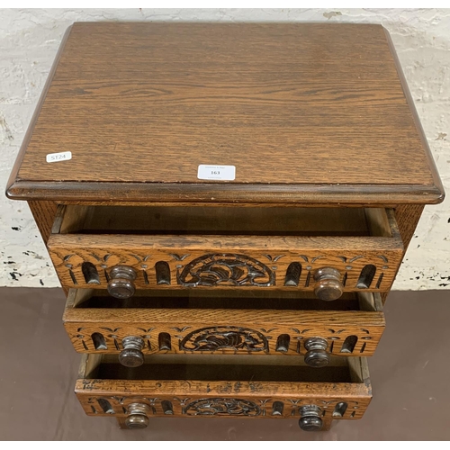 163 - A carved oak chest of three drawers - approx. 69cm high x 44cm wide x 32.5cm deep