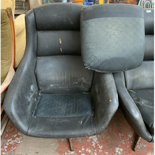 173 - A pair of 1960s black vinyl and fibreglass swivel egg chairs - approx. 93cm high x 77cm wide