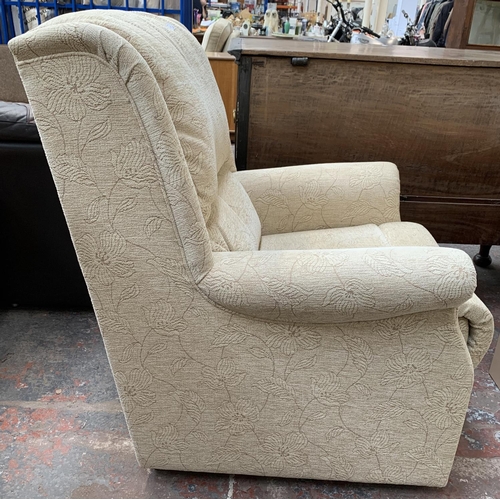 184 - A pair of cream floral upholstered armchairs