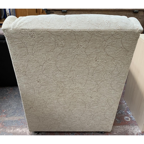 184 - A pair of cream floral upholstered armchairs