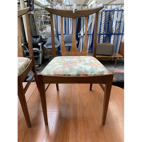 188 - A mid 20th century teak extending dining table with six G Plan Brasilia teak and upholstered dining ... 