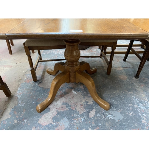 193 - An oak extending pedestal dining table - approx. 75cm high x 160cm long x 118cm wide together with f... 