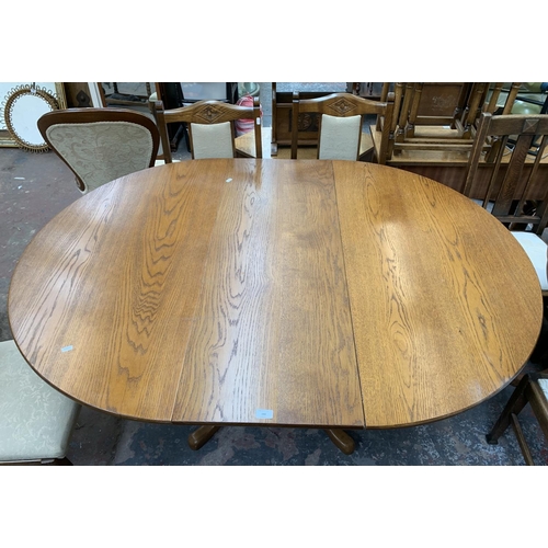 193 - An oak extending pedestal dining table - approx. 75cm high x 160cm long x 118cm wide together with f... 