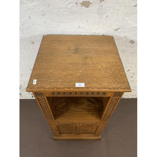 194 - A carved oak single door cabinet - approx. 84cm high x 44cm wide x 41cm deep