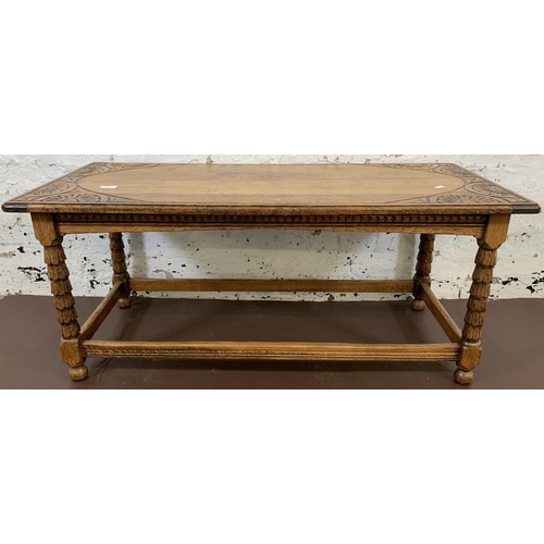 195 - A carved oak rectangular coffee table - approx. 45cm high x 105cm long x 45cm wide