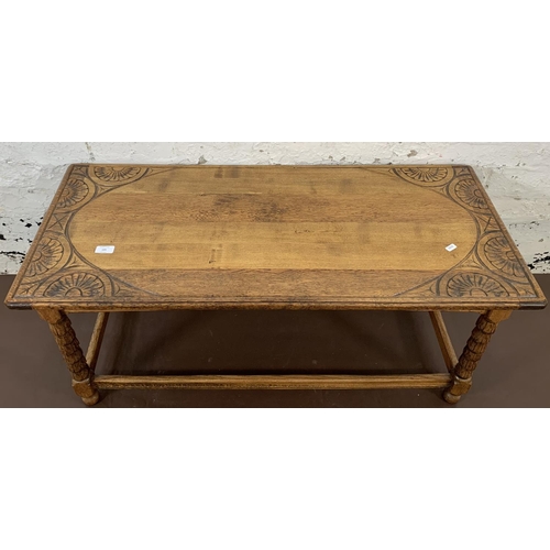 195 - A carved oak rectangular coffee table - approx. 45cm high x 105cm long x 45cm wide