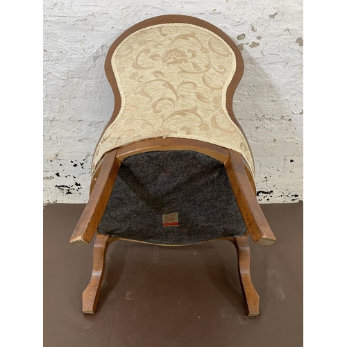 196 - A Victorian style mahogany and cream upholstered balloon back nursing chair - approx. 90cm high x 57... 