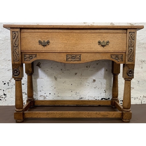 200 - A carved oak hall table with lower stretchers and one drawer - approx. 68cm high x 92.5cm long x 36.... 