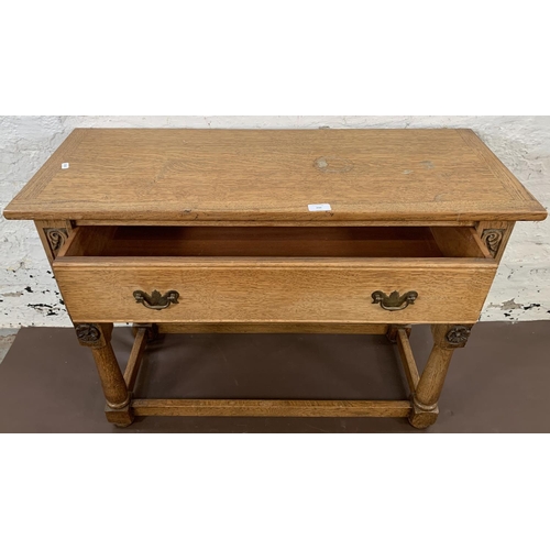 200 - A carved oak hall table with lower stretchers and one drawer - approx. 68cm high x 92.5cm long x 36.... 