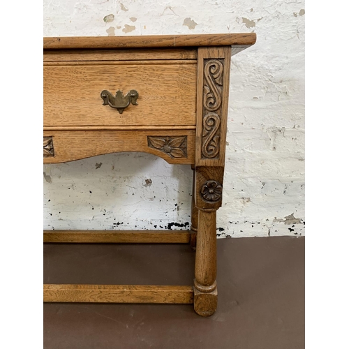 200 - A carved oak hall table with lower stretchers and one drawer - approx. 68cm high x 92.5cm long x 36.... 