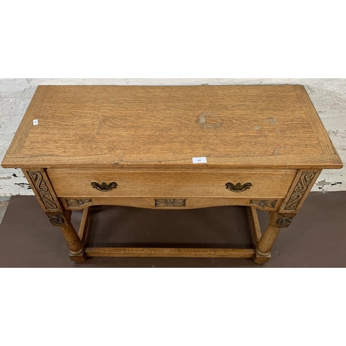 200 - A carved oak hall table with lower stretchers and one drawer - approx. 68cm high x 92.5cm long x 36.... 