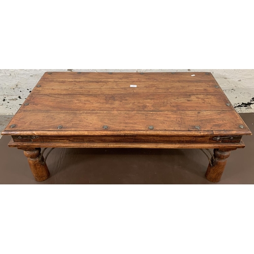 202 - An Indonesian hardwood rectangular coffee table - approx. 40cm high x 110cm long x 59cm wide