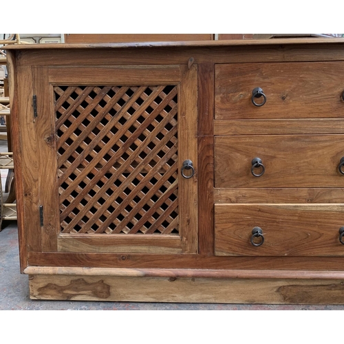 207 - An Indonesian hardwood sideboard with two latticework cupboard doors and three central drawers - app... 