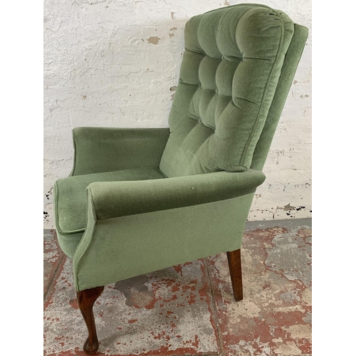 227 - A pair of vintage green fabric upholstered button back armchairs on cabriole supports - approx. 107c... 