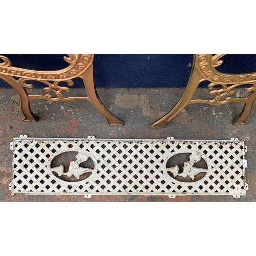 34 - Two cast iron garden bench accessories, one pair of bench ends and one bench back support