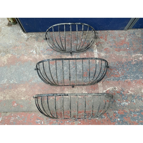 236 - Three cast metal and black painted wall hanging planters