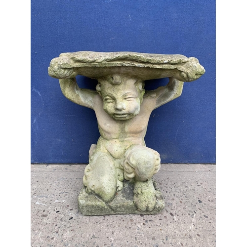 240 - A cast stone garden side table on cherub base - approx. 46cm high x 37cm wide