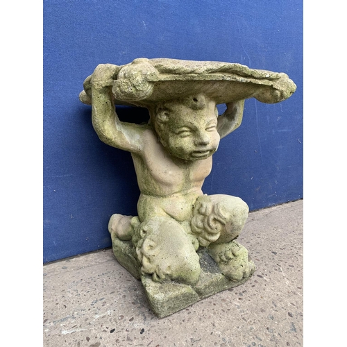 240 - A cast stone garden side table on cherub base - approx. 46cm high x 37cm wide