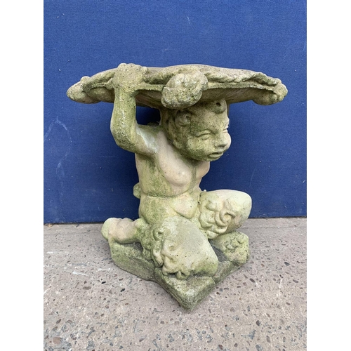 240 - A cast stone garden side table on cherub base - approx. 46cm high x 37cm wide