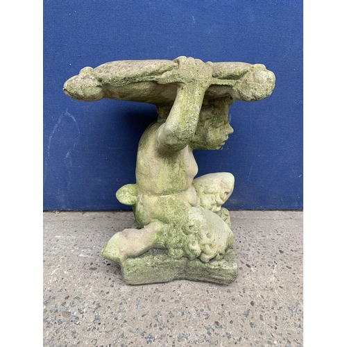 240 - A cast stone garden side table on cherub base - approx. 46cm high x 37cm wide