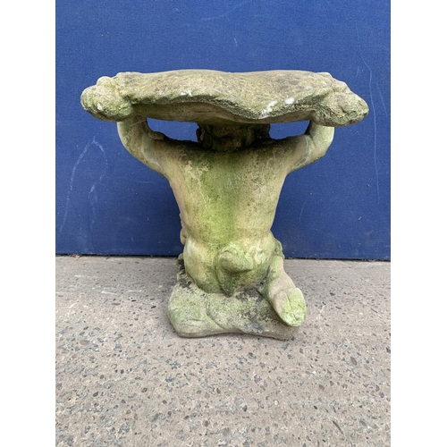 240 - A cast stone garden side table on cherub base - approx. 46cm high x 37cm wide