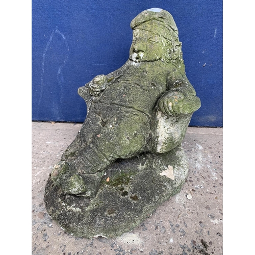 241 - A cast stone sleeping gnome garden statue - approx. 39cm high