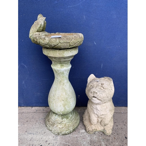 242 - Two cast stone garden accessories, one dog statue - approx. 33cm high and one birdbath - approx. 63c... 