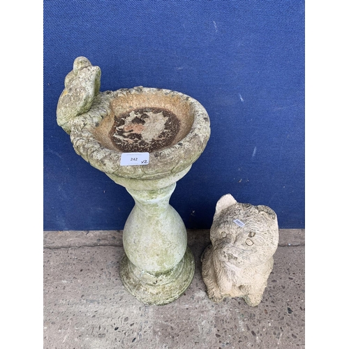 242 - Two cast stone garden accessories, one dog statue - approx. 33cm high and one birdbath - approx. 63c... 