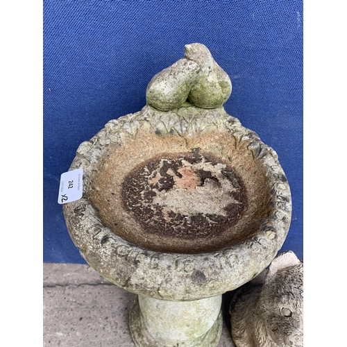 242 - Two cast stone garden accessories, one dog statue - approx. 33cm high and one birdbath - approx. 63c... 