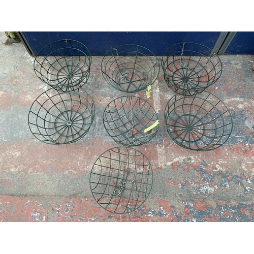 237 - A quantity of green painted metal hanging basket planters