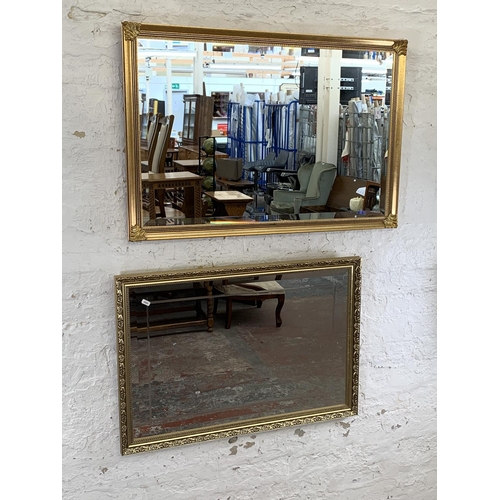 250 - Two modern gilt framed bevelled edge wall mirrors - largest approx. 65cm high x 94cm wide