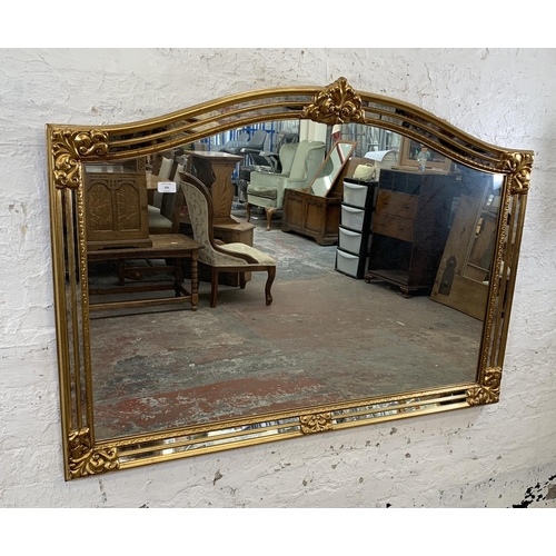 256 - A modern gilt framed French style overmantle mirror - approx. 90cm high x 130cm wide