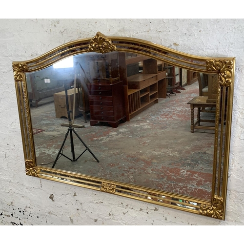 256 - A modern gilt framed French style overmantle mirror - approx. 90cm high x 130cm wide