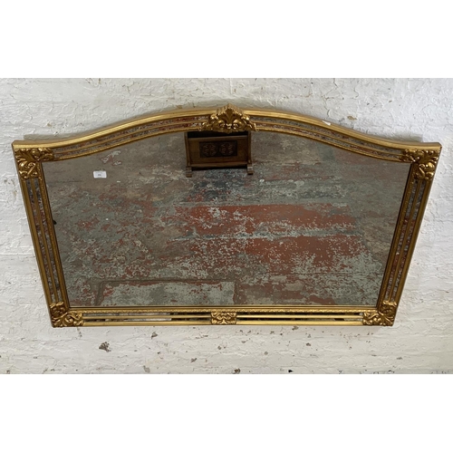 256 - A modern gilt framed French style overmantle mirror - approx. 90cm high x 130cm wide