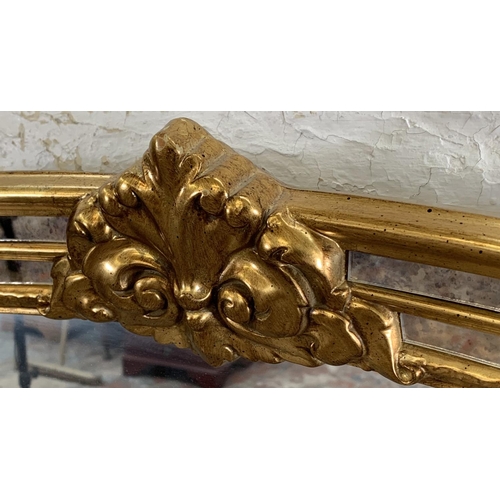 256 - A modern gilt framed French style overmantle mirror - approx. 90cm high x 130cm wide