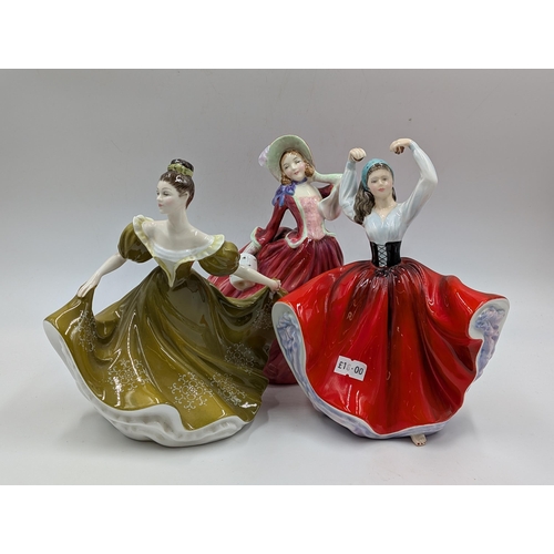 404 - Three Royal Doulton figurines, Autumn Breezes, Karen HN2388 and Lynne HN2329