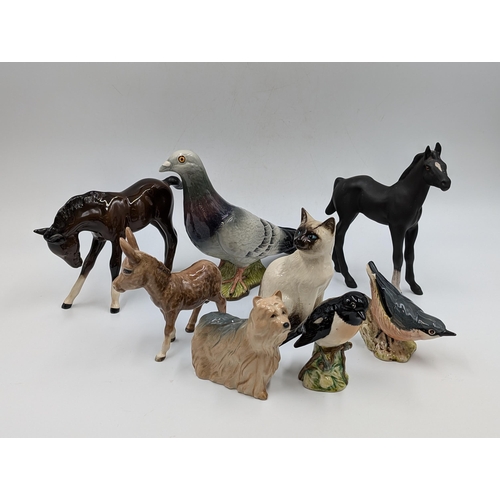 421 - Eight Beswick ceramic animal figurines to include Pigeon model no. 1383, Nuthatch model no. 2413, Do... 