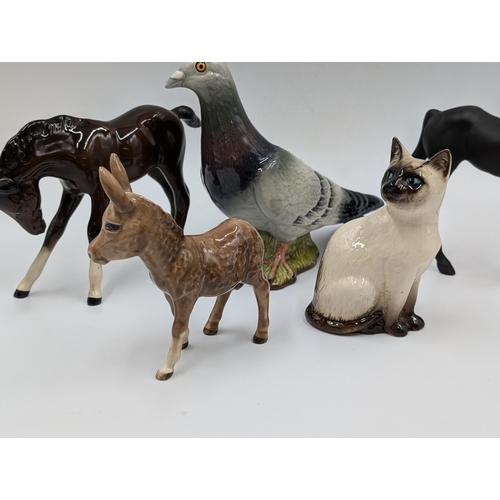 421 - Eight Beswick ceramic animal figurines to include Pigeon model no. 1383, Nuthatch model no. 2413, Do... 