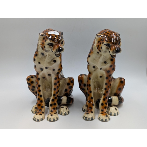 458 - Two ceramic seated cheetah figurines - each approx. 24.5cm high