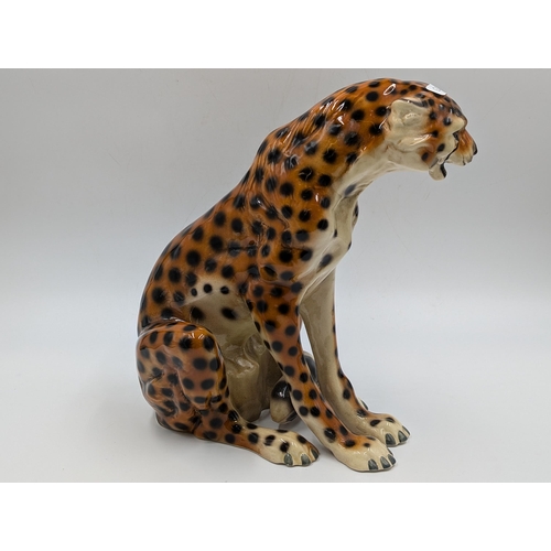 458 - Two ceramic seated cheetah figurines - each approx. 24.5cm high