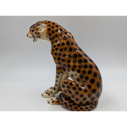 458 - Two ceramic seated cheetah figurines - each approx. 24.5cm high