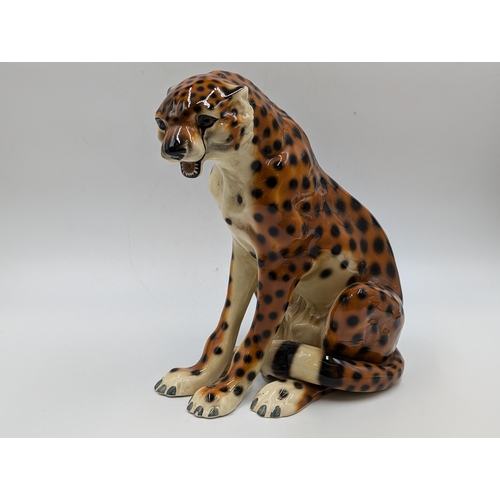 458 - Two ceramic seated cheetah figurines - each approx. 24.5cm high