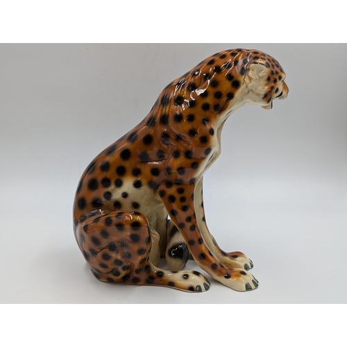 458 - Two ceramic seated cheetah figurines - each approx. 24.5cm high