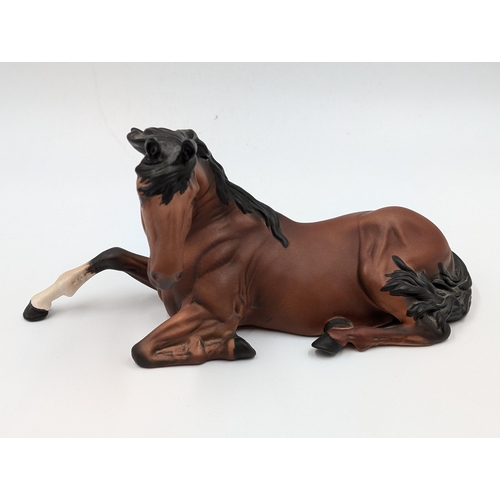 459 - A Beswick matte finish figure of a seated bay horse