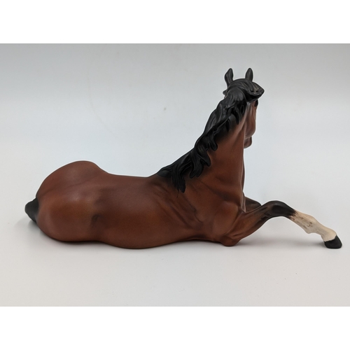 459 - A Beswick matte finish figure of a seated bay horse