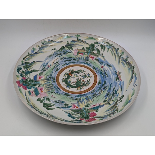 467 - An Oriental hand painted circular wall charger with six character mark to reverse - approx. 36.5cm i... 