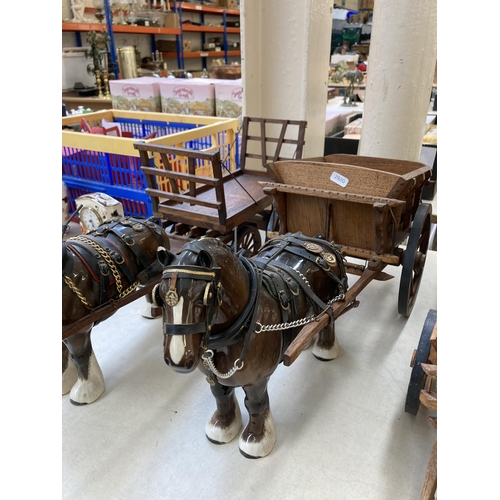 505 - Three ceramic shire horses with wooden carts together with one handmade Romany Rose gypsy caravan